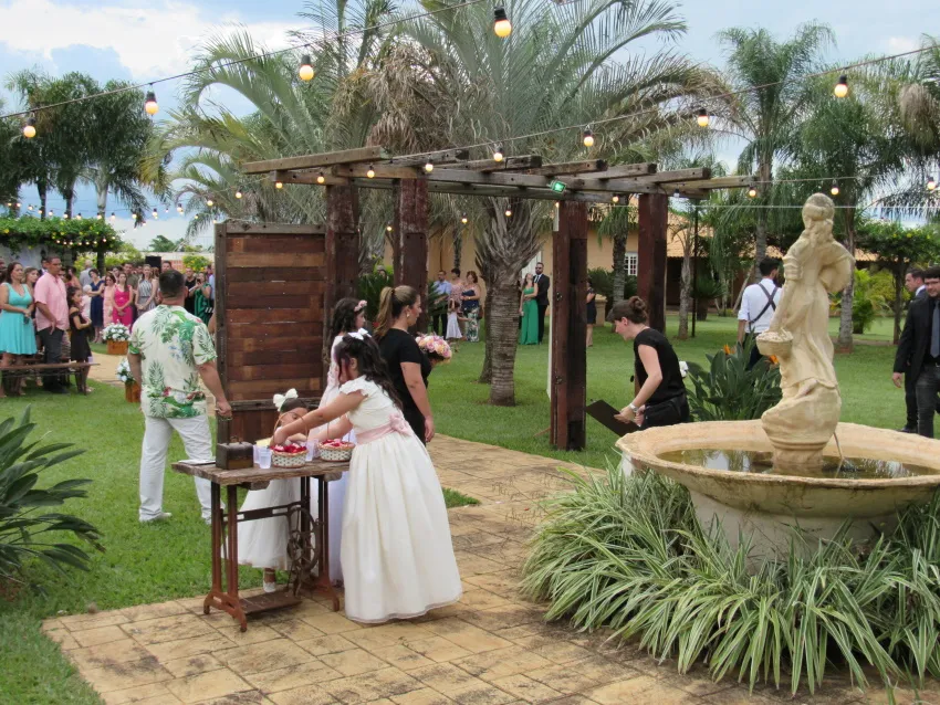 Convidados no jardim junto à fonte de pedra